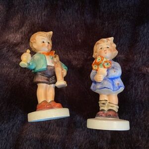 Goebel made in West Germany 1 girl holding flower 1 boy with horse and trumpet